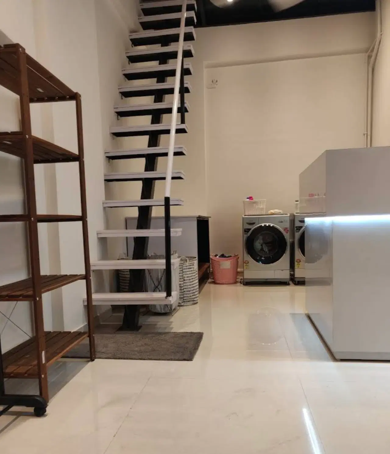 Inside a Kleansweep store: shelves, stairs to the upper floor and washing machines